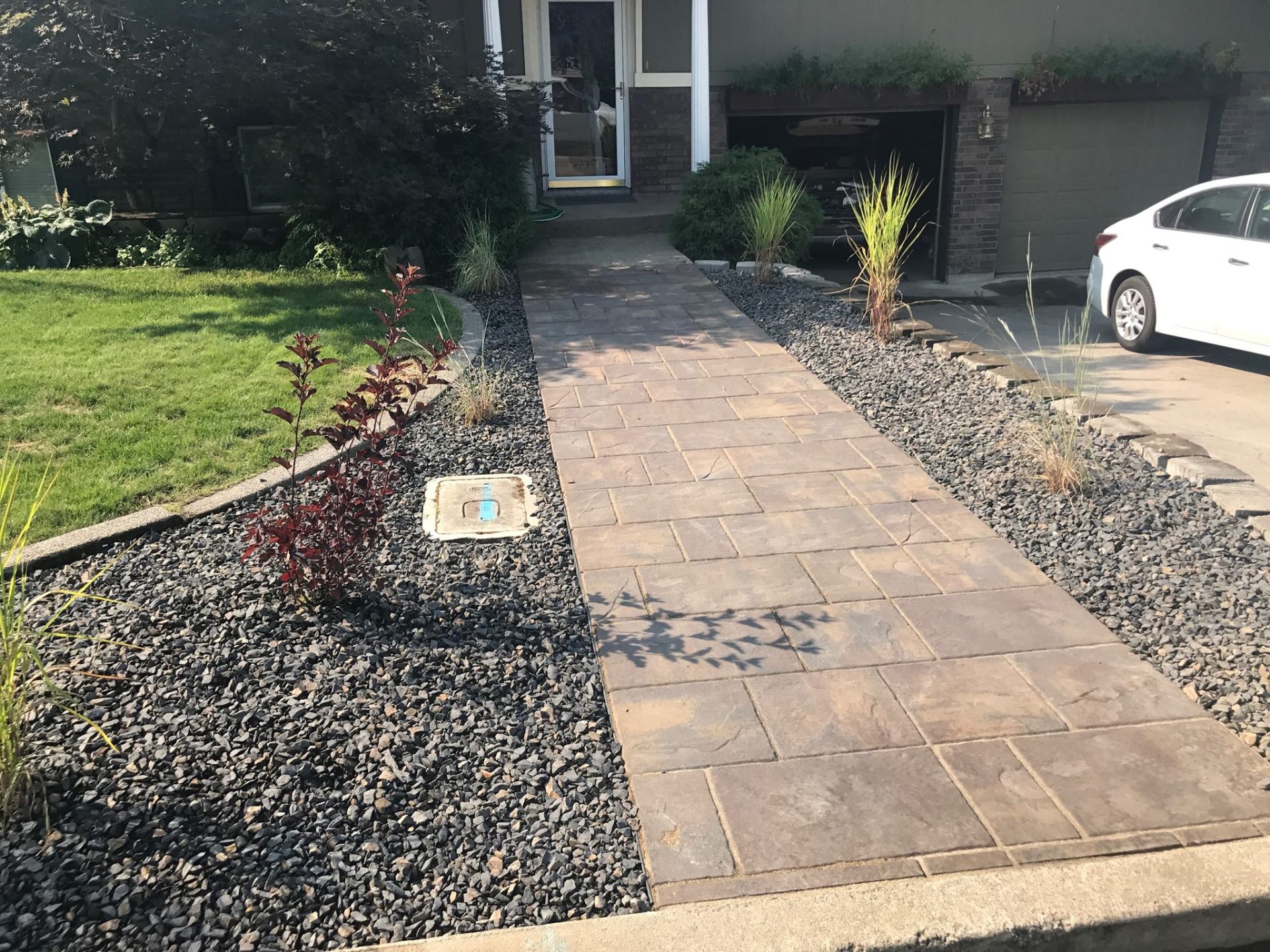 Modern paver entry walkway with rock beds